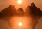Violence and Faith- Sunrise over a pond